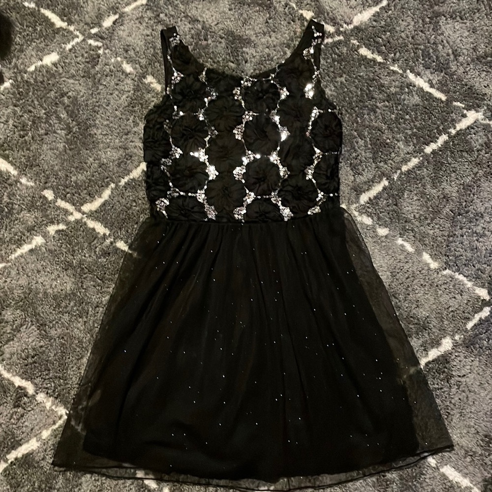 Formal dress with black flowers and silver sequins.